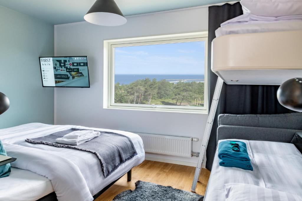 Postel nebo postele na pokoji v ubytování First Hotel Kokoloko