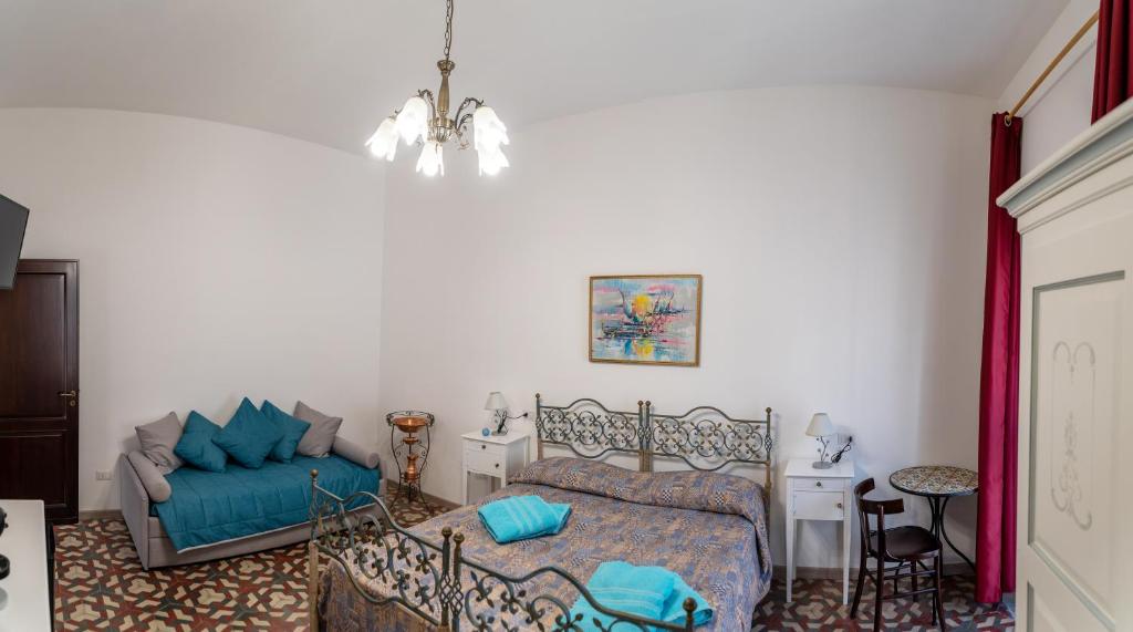 - une chambre avec un lit et un canapé dans l'établissement Casa degli Artisti Diamante, à Diamante