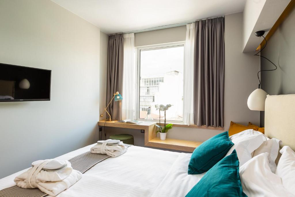 Posteľ alebo postele v izbe v ubytovaní St. Bjur Suites