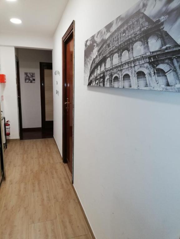a hallway with a painting of the coliseum at Domus Vatican Holiday's in Rome