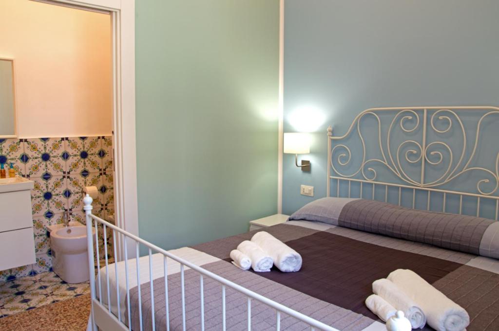 a bedroom with a bed with towels on it at Valente rooms in Agropoli