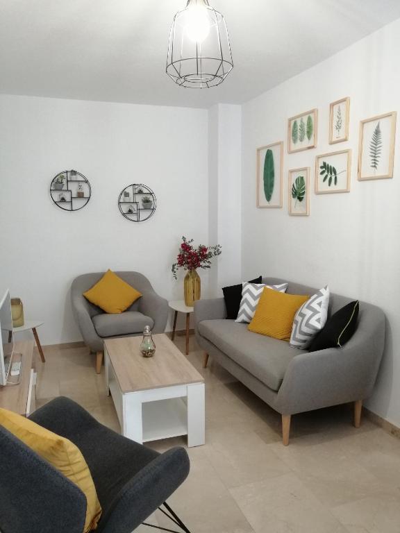 a living room with two couches and a table at Sueños Mozárabes in Córdoba