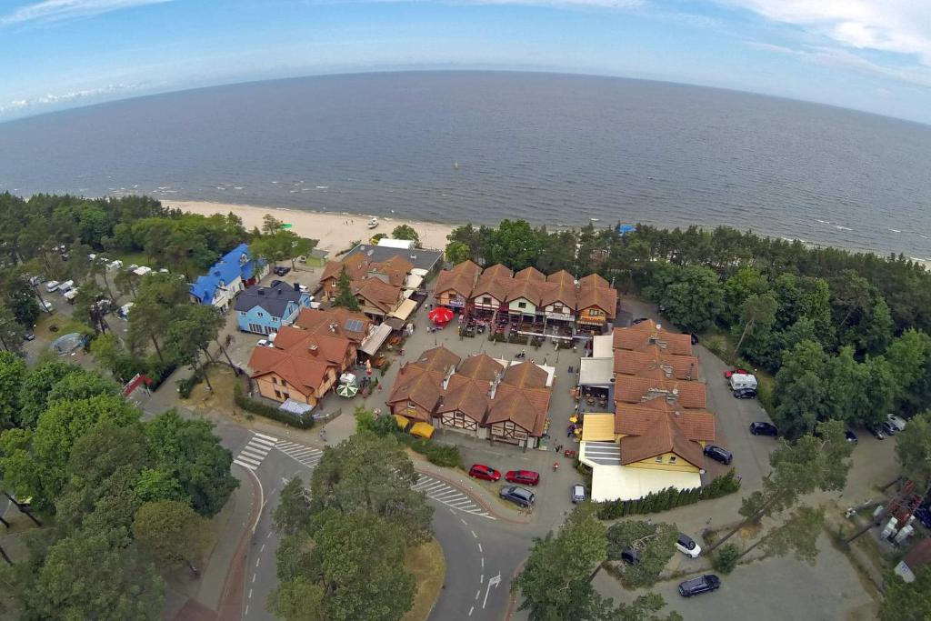 an overhead view of a group of houses by the water at Siódme Niebo-komfortowe pokoje nad samym morzem in Stegna