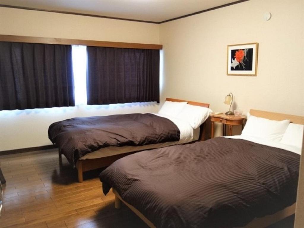 a hotel room with two beds and a window at Corpo Umeyama 2F / Vacation STAY 3912 in Mibu