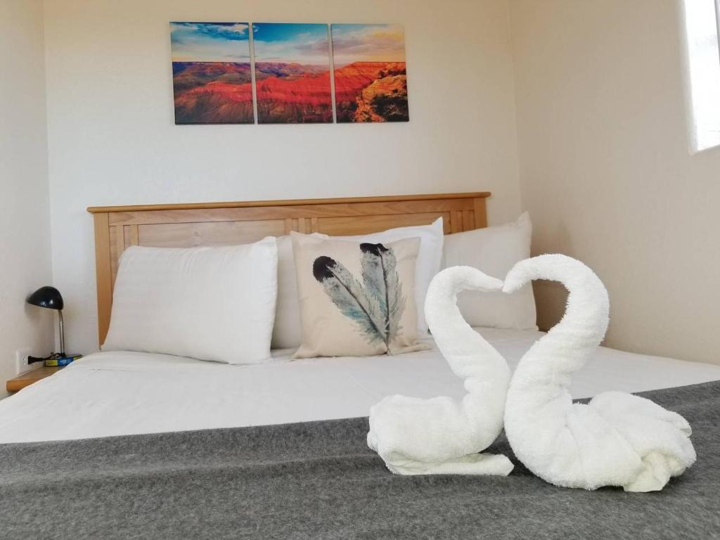 two swans sitting on a bed in a bedroom at 072B Affordable Retreat nr South Rim Sleeps 4- no kitchenette in Valle