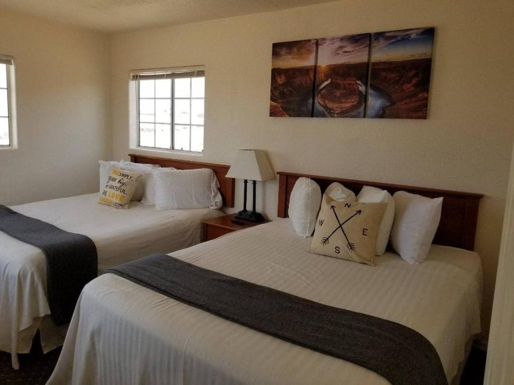 a hotel room with two beds and two windows at 071A Private Studio near South Rim Sleeps 6- No Kitchen in Valle