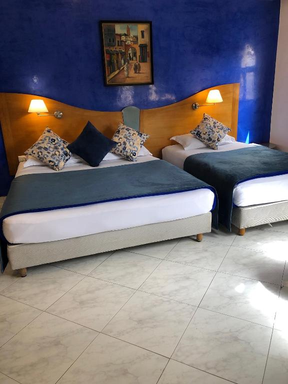 Postel nebo postele na pokoji v ubytování Hotel Mounia