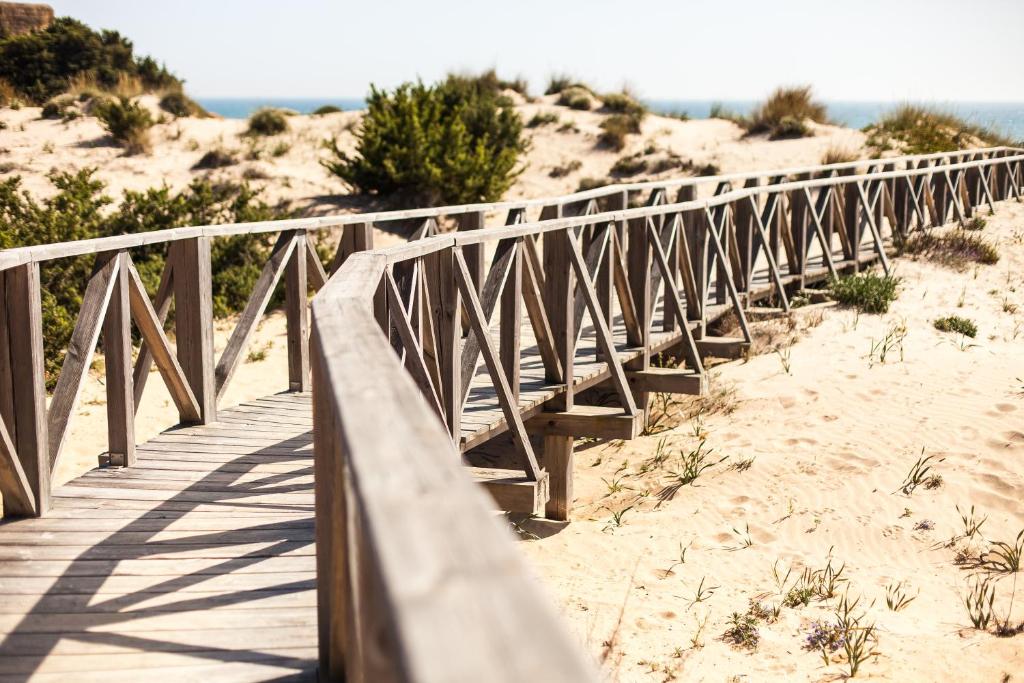 a wooden bridge over the sand at the beach at Valentin Sancti Petri in Chiclana de la Frontera