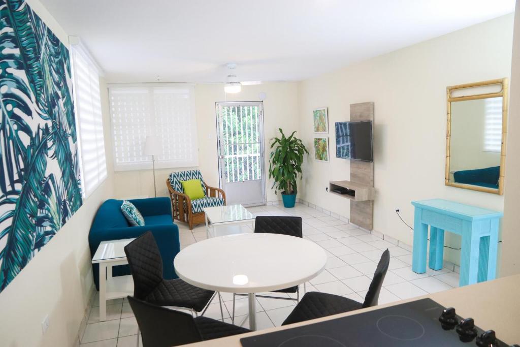 a living room with a table and chairs at Buena Vida Apartments in Rincon