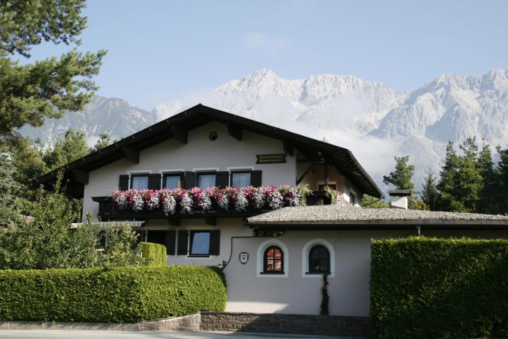 a white house with flowers on the top of it at Appartement Isabella in Mieming