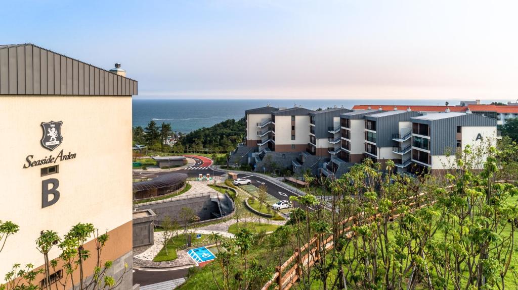 an aerial view of a resort with the ocean in the background at Seaside Arden in Seogwipo