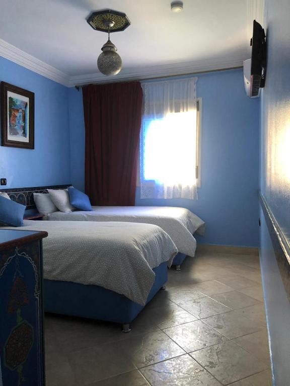Postel nebo postele na pokoji v ubytování Hotel Tarek