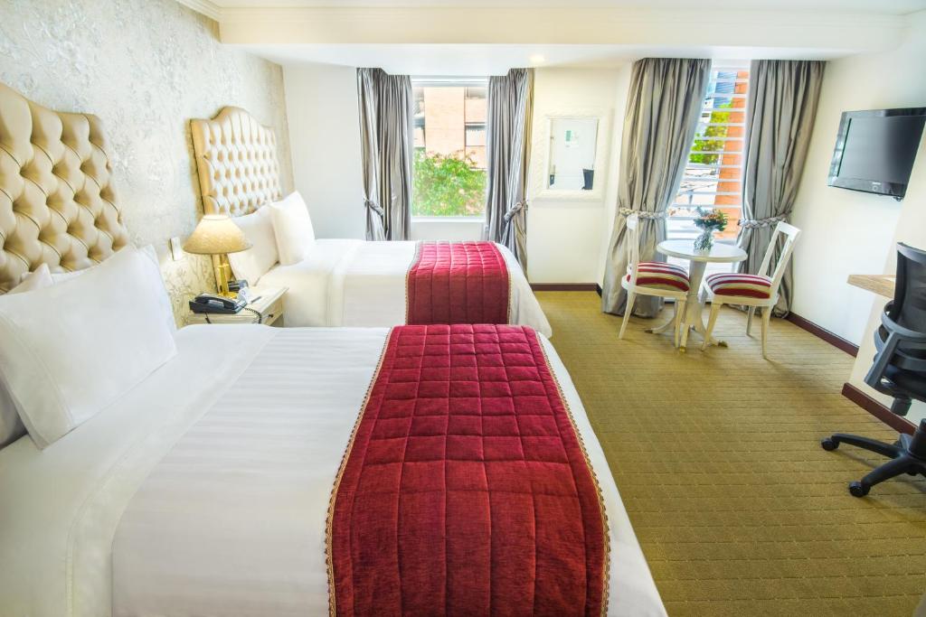 Postel nebo postele na pokoji v ubytování GHL Hotel Hamilton