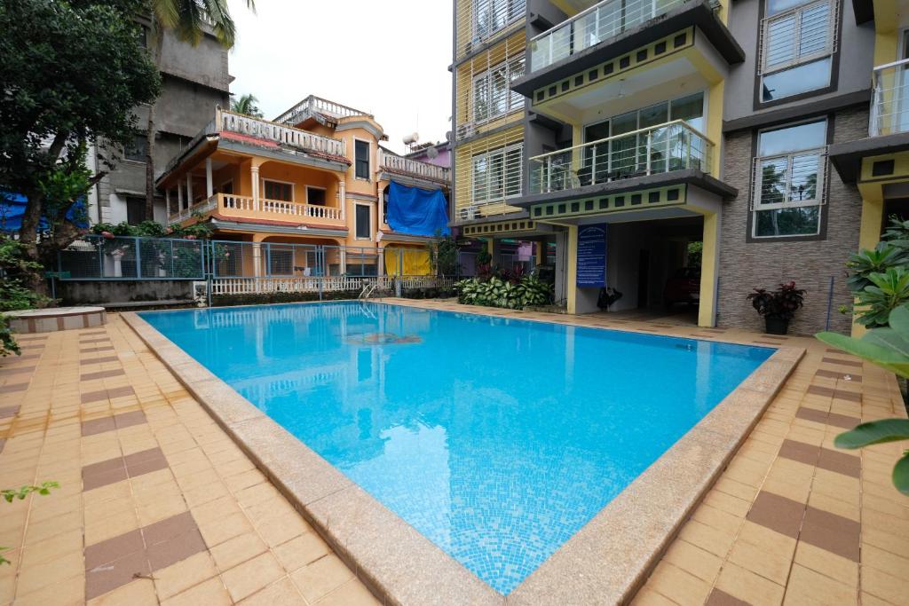 a swimming pool in the middle of a building at Nishka holiday home in Candolim