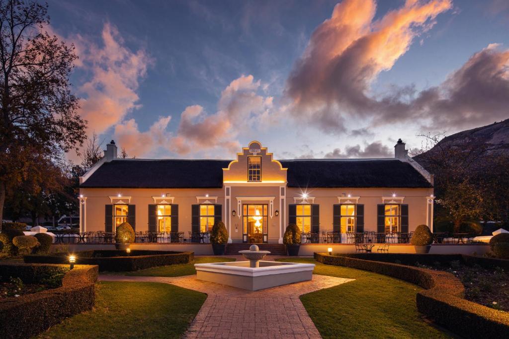 a large building with a clock on the front of it at Grande Roche Hotel in Paarl
