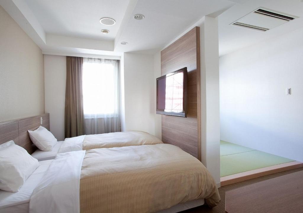 Postel nebo postele na pokoji v ubytování Hotel Sorriso Hamamatsu