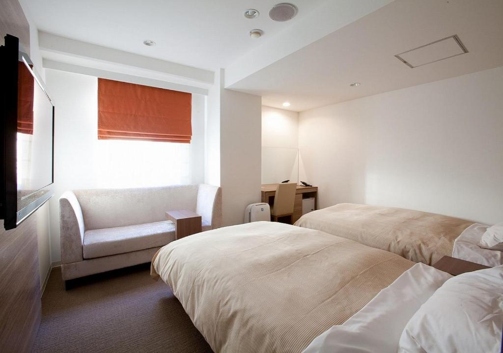 Postel nebo postele na pokoji v ubytování Hotel Sorriso Hamamatsu