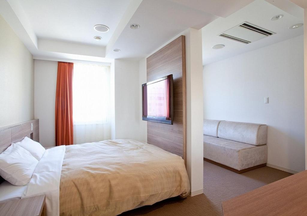Postel nebo postele na pokoji v ubytování Hotel Sorriso Hamamatsu