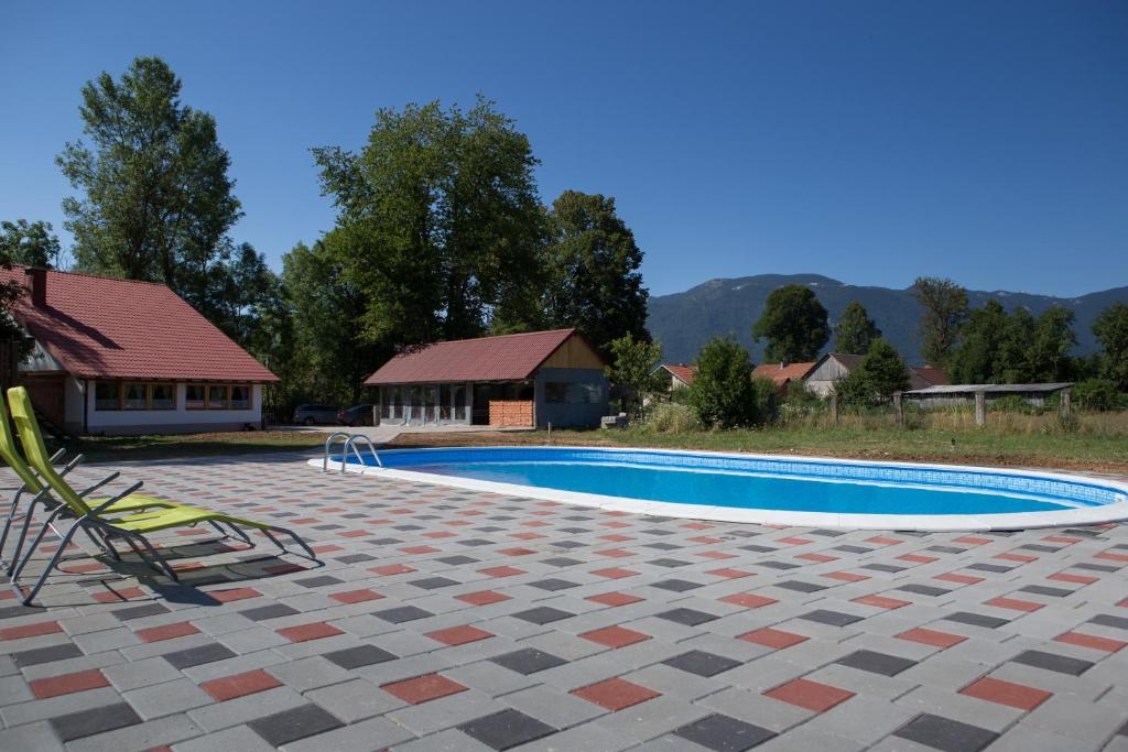 a swimming pool in front of a house at Liki Niki Spa in Gospić