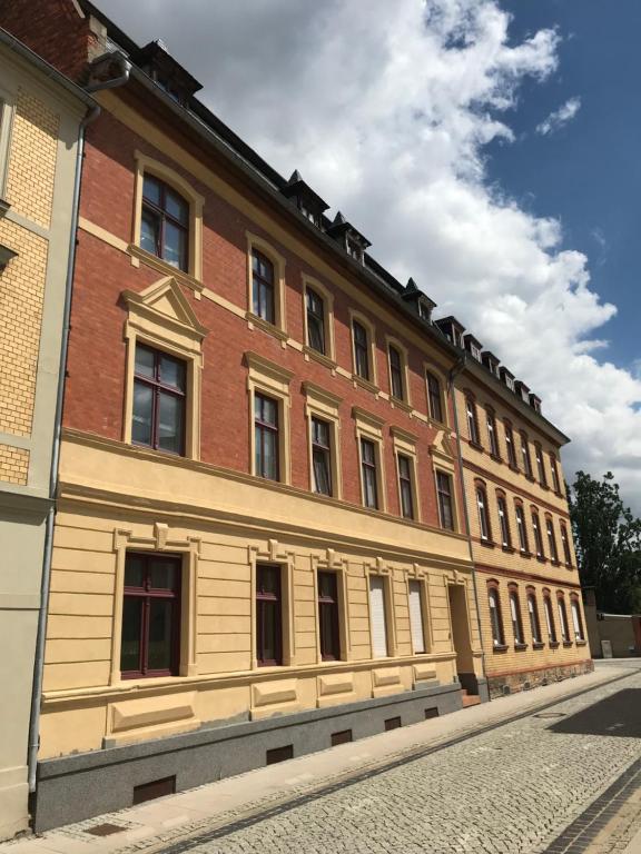 a large brick building with windows on a street at Tränental in Staßfurt