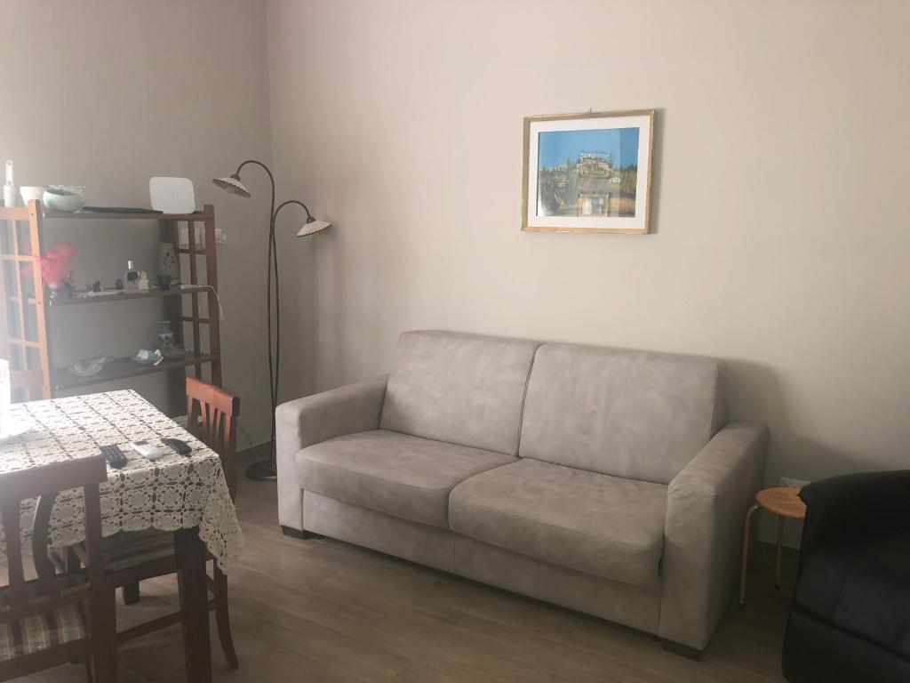 a living room with a couch and a table at GIUSY’ S HOUSE in Sulmona