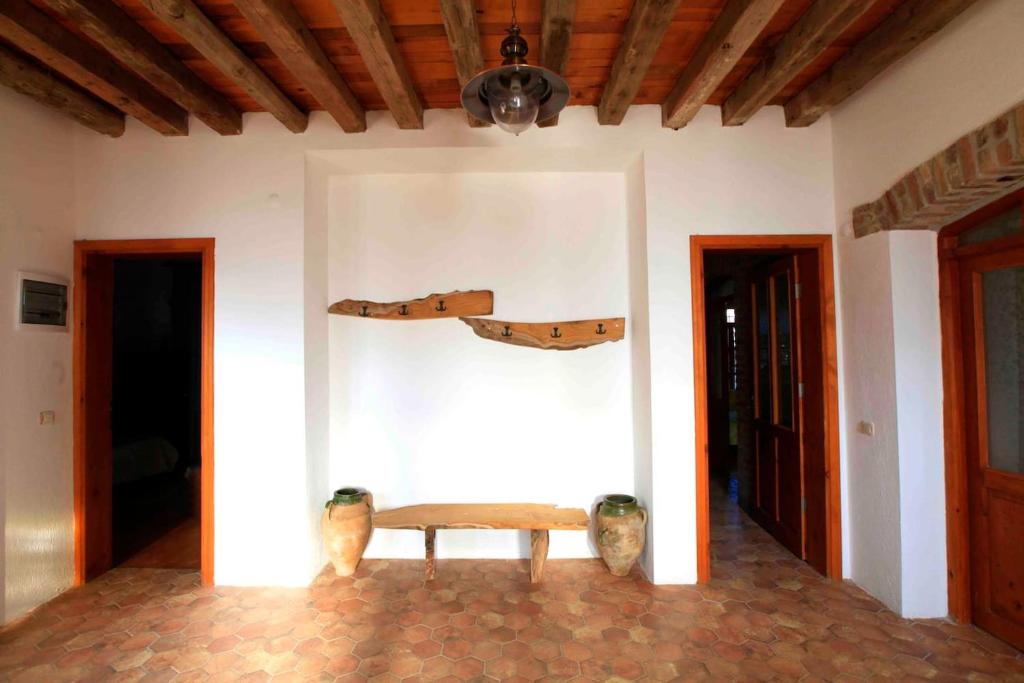 a wooden bench in a room with two shoes on the wall at Side Cottagehause in Side