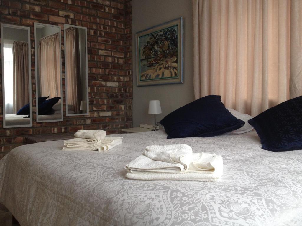 a bedroom with a bed with towels on it at Ocean Melody in Swakopmund