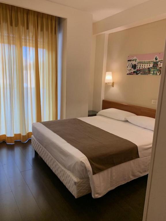 Postel nebo postele na pokoji v ubytování Hotel Sisto V