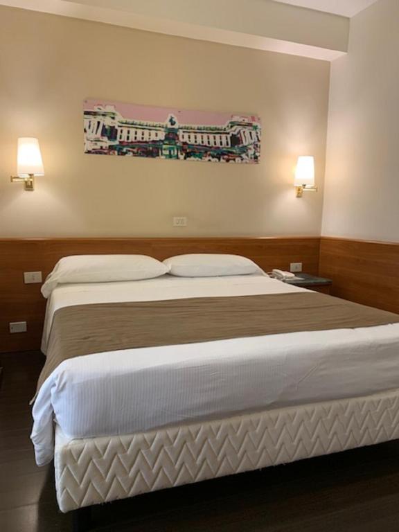 Postel nebo postele na pokoji v ubytování Hotel Sisto V