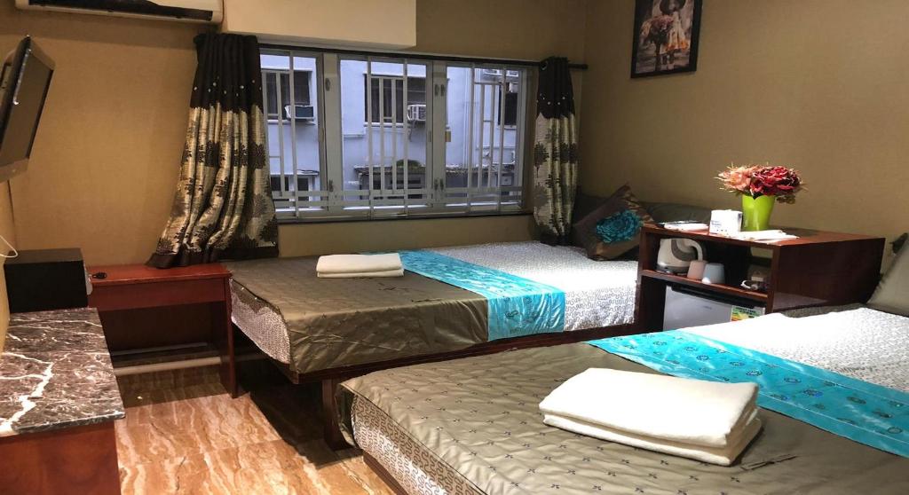 Postel nebo postele na pokoji v ubytování Rich Hostel