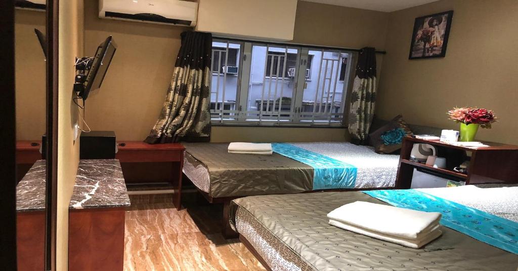 Postel nebo postele na pokoji v ubytování Rich Hostel