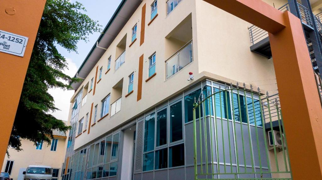 a building with glass balconies on the side of it at Monarch Hotel in Accra
