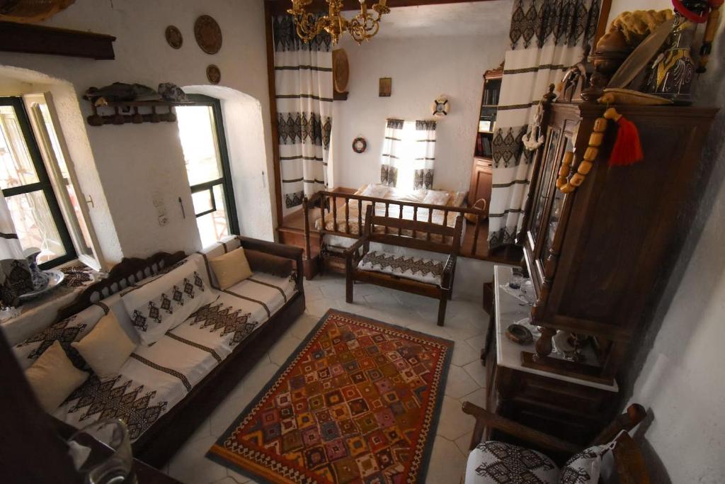 an overhead view of a living room with a couch and chairs at The little house on the hill of Myrties in Myrties