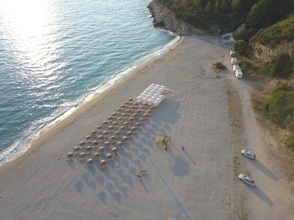 an overhead view of a beach with a bunch of umbrellas at Riviera Perdika Hotel in Perdika