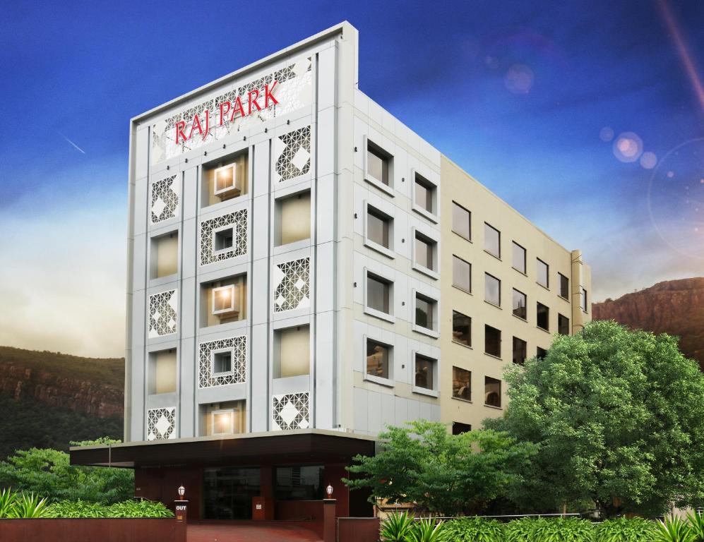 a rendering of a white building with a sign on it at Raj Park- Hill View in Tirupati