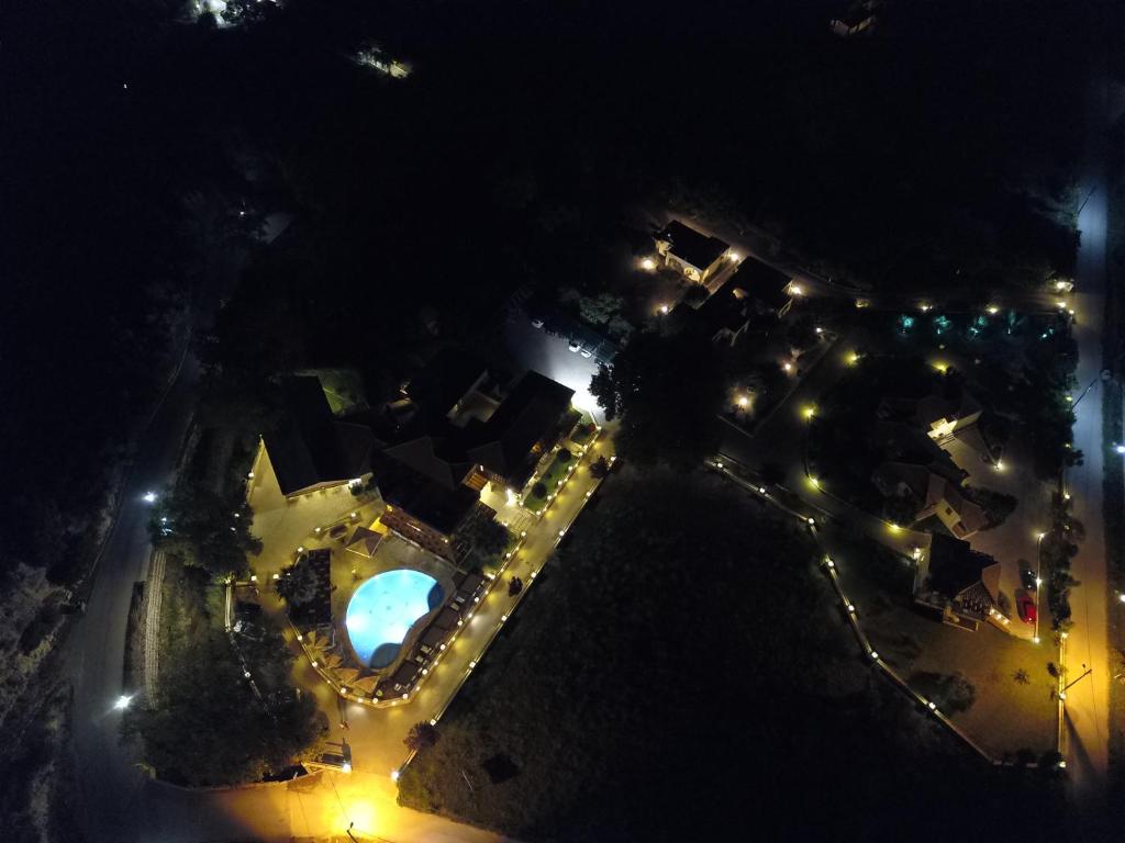 an overhead view of a park at night with lights at Riviera Perdika Hotel in Perdika