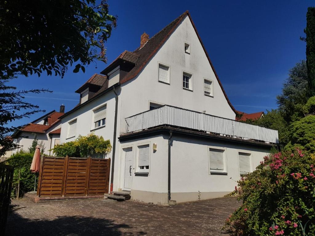 a large white house with a wooden gate at Weingut Knauer in Dettelbach