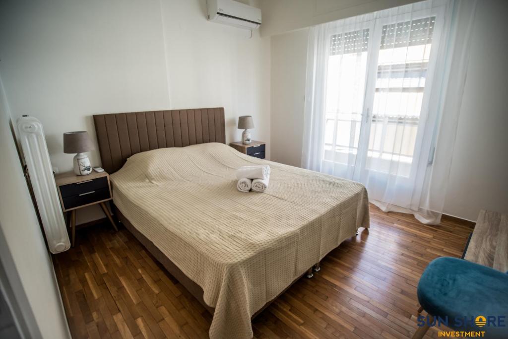 a bedroom with a bed with two towels on it at Explore Greece from Close the Sea Apartment in Chalkida