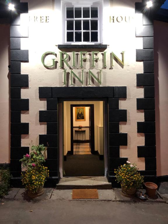 a black and white building with a sign that reads grittle inn at The Griffin Llyswen in Brecon