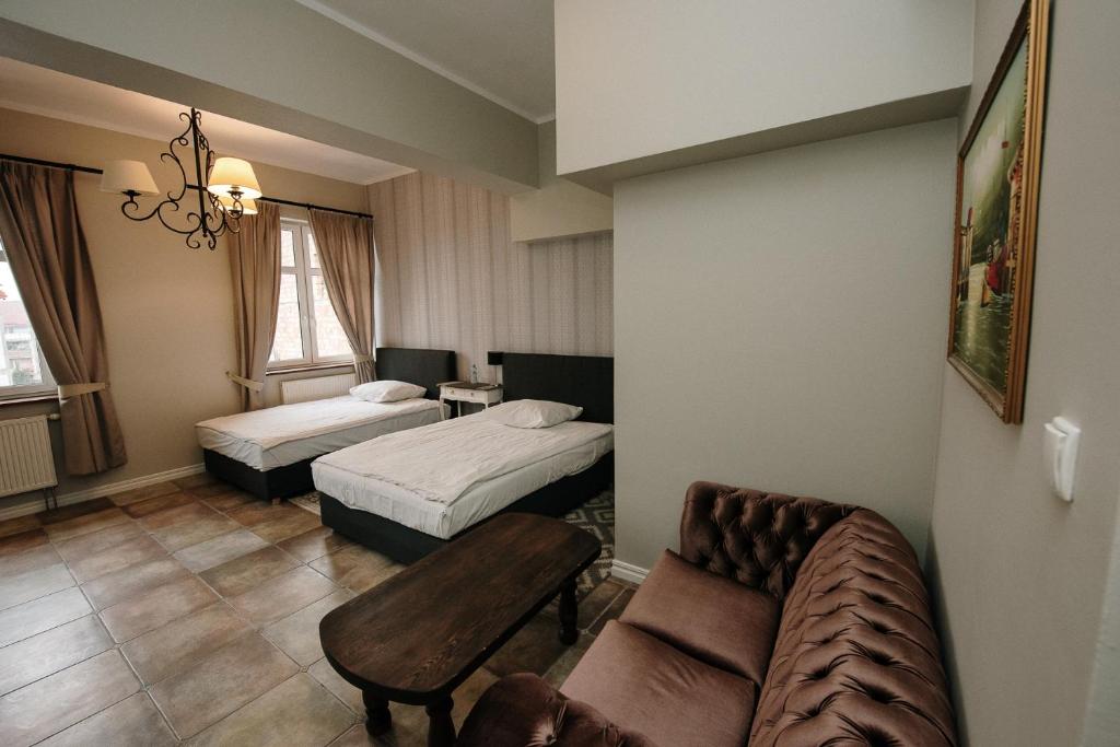 Postel nebo postele na pokoji v ubytování Apartamenty Kuźnia