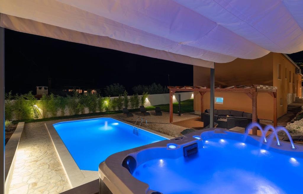 Bazén v ubytovaní Villa Village Idylle with heated pool, sauna, jacuzzy and private parking alebo v jeho blízkosti