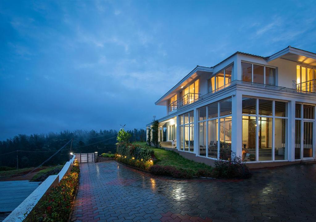 a large house with a lot of windows at StayVista at The Lilly with Breakfast & Yoga in Ooty