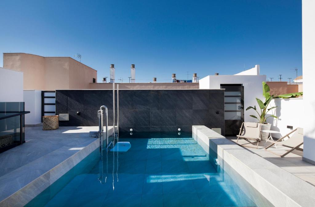 a swimming pool on the roof of a building at Casa Noa Apartments in Seville