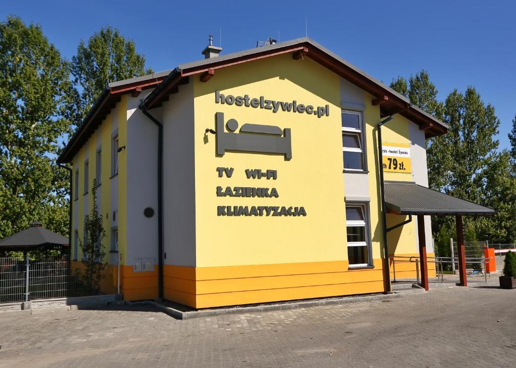 a yellow building with a sign on the side of it at Hostel Żywiec in Żywiec