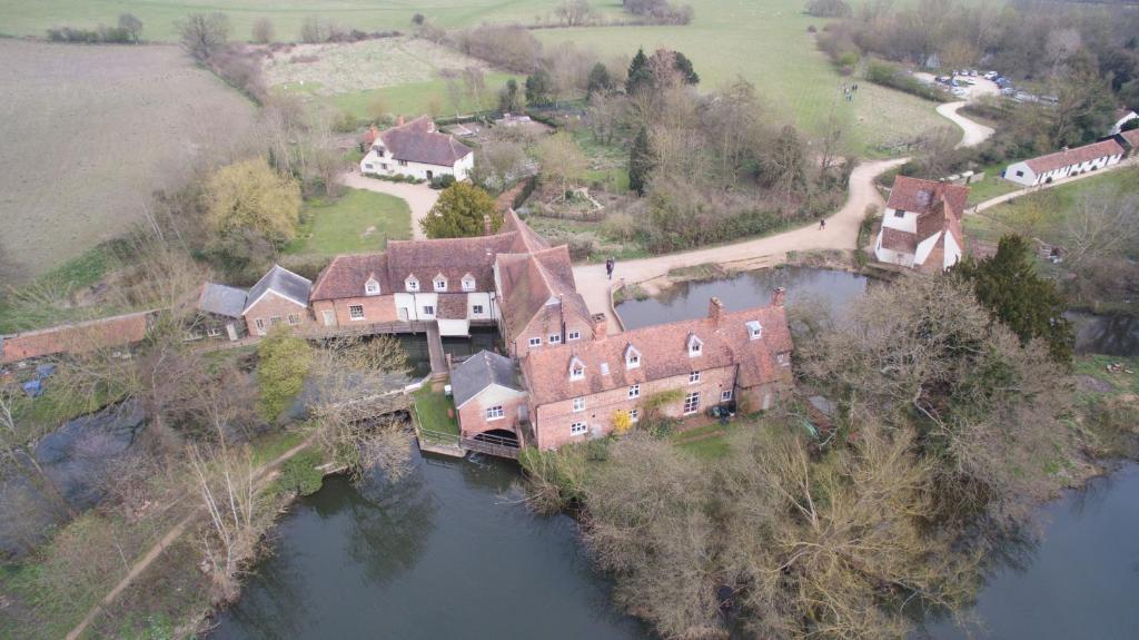 an aerial view of a house on an island in the water at FSC Flatford Mill Hostel in East Bergholt