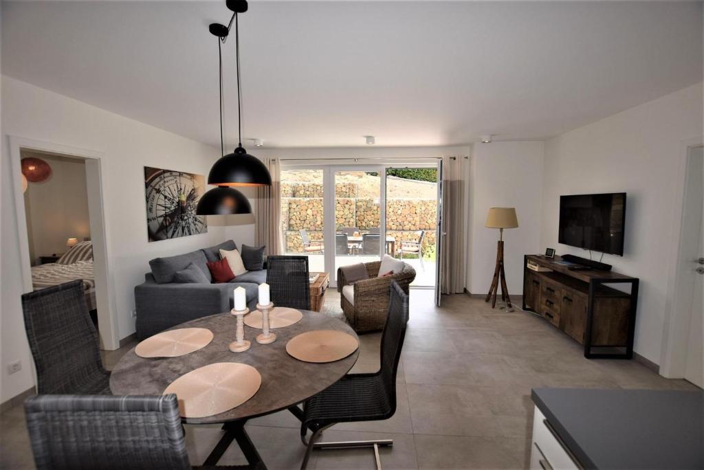 a living room with a table and a couch at Compass-App-5 in Hohwacht