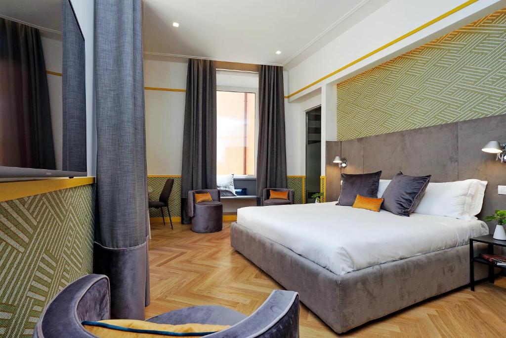 a hotel room with a bed and a couch at Roma Five Suites in Rome