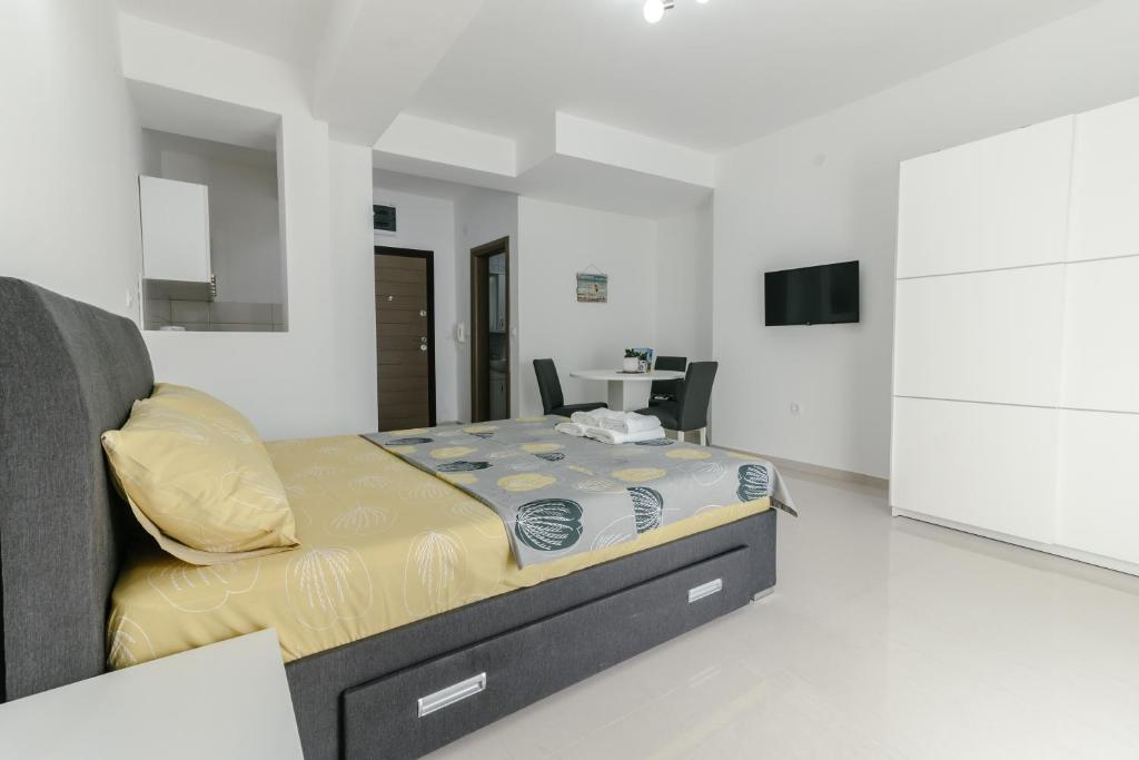 a bedroom with a bed and a table in it at Apartments Lakeside Elesec in Ohrid