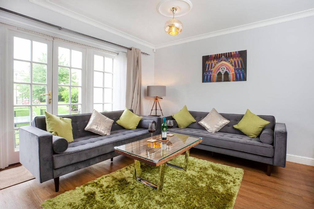 a living room with a couch and a table at Thomas, off Leeman Road, Sleeps 9 in York