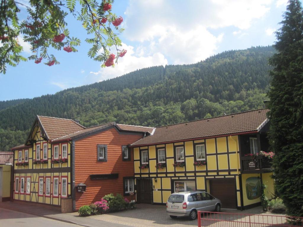 a building with a car parked in front of it at Haus Brigitte in Bad Lauterberg